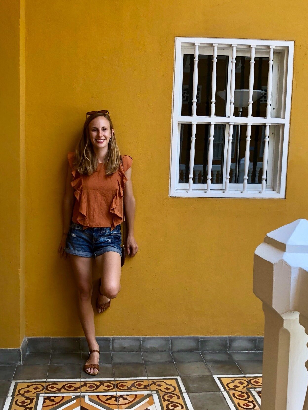 Brooke against a yellow wall
